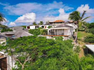 a group of houses on a hill with trees at Villa Olive Sea View Cocoon in Oyster Pond in Oyster Pond