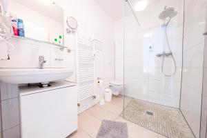 a white bathroom with a sink and a shower at Hotel Bären in Hechingen +112 photos