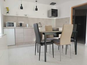 a kitchen with a table and chairs in a room at Stefánia Suites in Szeged