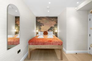 a bedroom with a bed with a painting on the wall at 1 Bed Flat in London in London