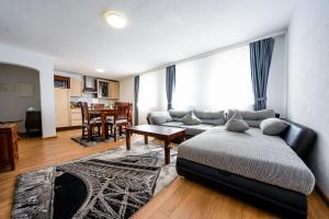 a living room with a bed and a dining room at Hotel Bären in Hechingen