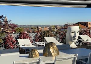 a table with chairs and a large head on it at Langhe Panorama in Alba