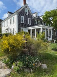 a house with a garden in front of it at The Copper Swan in Wellfleet
