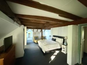 a bedroom with a bed and a tv in it at The Copper Swan in Wellfleet