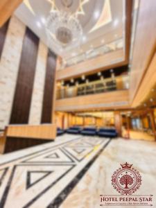 a lobby with a hotel peruvianstar logo on the floor at Hotel Peepal Star in Siwān