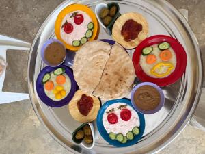 a plate of food with breakfast foods on it at كامب سيوة اواسيس Siwa Oasis Camp in Siwa