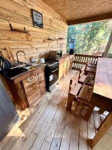 a kitchen with a stove and a table and chairs at Glamping Puertecillo Surf & Camp in Puertecillo +151 photos