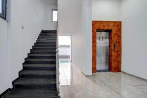 a staircase leading to a door in a white building at Collection O Kanifnath Trek Pune in Jadhavwadi