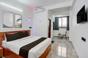 a bedroom with a bed and a television in it at Collection O Kanifnath Trek Pune in Jadhavwadi +30 photos