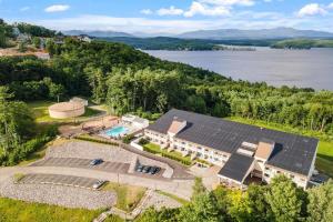 an aerial view of a house with solar panels on it at Lake Views Close to Weirs in Cedar Lodge Complex in Laconia