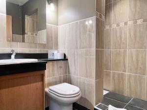 a bathroom with a toilet and a sink at Orchard Cottage in Willingham