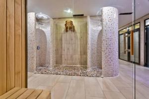 a lobby with a glass door with a wall of stones at Tomy Forest Cigar Bar in Ocka Gora +13 photos