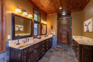 a bathroom with two sinks and a large mirror at Overlook Estate in The Farm in Banner Elk +80 photos
