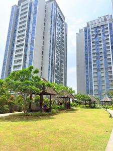 a park in front of some tall buildings at Apartment Podomoro Lincoln Delipark in Medan