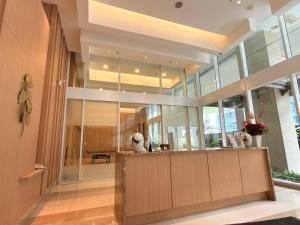 a lobby of a building with large windows at Apartment Podomoro Lincoln Delipark in Medan +23 photos