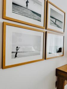 a row of framed photographs on a wall at Grace Living Studio 201 in Limassol