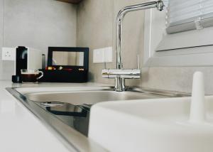 a kitchen with a sink and a faucet at Grace Living Studio 201 in Limassol +43 photos