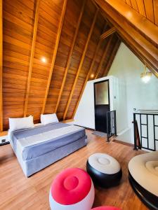 a bedroom with a bed in a room with wooden ceilings at Shenu Villa in Talpe