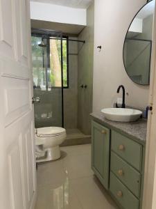 a bathroom with a toilet and a sink and a mirror at Cabañas Time Out in Santa Catalina +33 photos