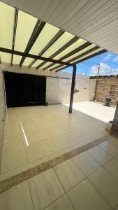 an empty patio with awning on a building at Casa aconchegante com piscina e wi-fi rápido in Aracaju