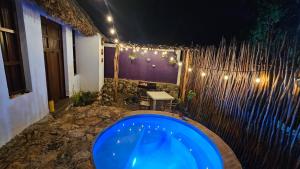a bathroom with a tub and a table and lights at Cabañas Los Gallitos Ecolodge 3 in Sacalum