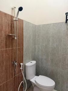 a bathroom with a toilet and a shower at patangpuluh homestay in Purwokerto +48 photos