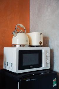 un forno a microonde con una teiera sopra di M Maison- Stay chill in District 1 ad Ho Chi Minh