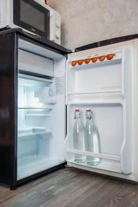 un frigorifero aperto con due bottiglie di soda di M Maison- Stay chill in District 1 ad Ho Chi Minh