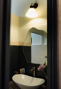 un bagno con lavandino e specchio di M Maison- Stay chill in District 1 ad Ho Chi Minh