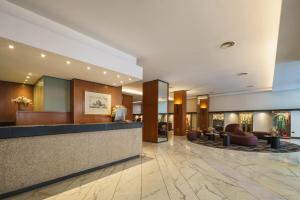 a lobby of a hotel with a reception desk at Exe Majestic in Naples