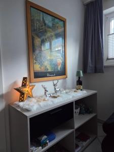 a white table with a painting on the wall at Ferienwohnung FeWe Wandern und Skifahren in Triesen +34 photos