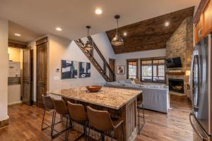 a kitchen and living room with a table and a couch at Overlook Nook at Eagles Nest in Elk Park
