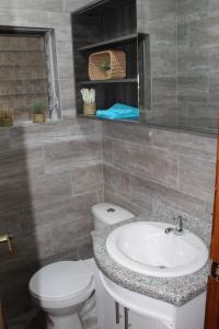 a bathroom with a toilet and a sink at Departamento La República in Cuenca