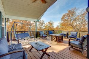 a porch with chairs and a table on a deck at Spacious Norfork Lake Home Game Room and Views! in Elizabeth
