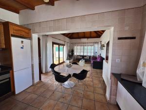 a kitchen and living room with a table and chairs at Villa Corralejo Beach in Corralejo