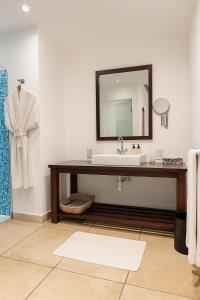 a bathroom with a sink and a mirror at Fairview Signature Suites in Dar es Salaam
