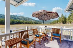 a porch with chairs and a table and an umbrella at Ranchita Avalon in Sierraville
