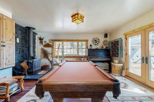 a room with a pool table and a fireplace at Ranchita Avalon in Sierraville