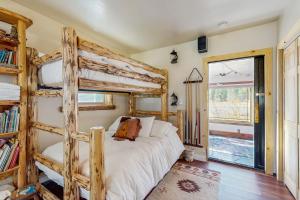 a bedroom with two bunk beds and a window at Ranchita Avalon in Sierraville