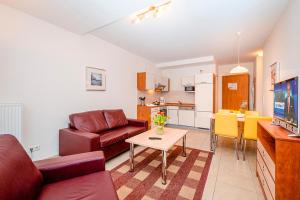 a living room with a couch and a table at Residenz Meeresblick D Fewo E5 in Rerik