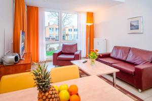 a living room with a couch and a table at Residenz Meeresblick D Fewo E5 in Rerik