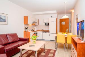 a living room with a couch and a table at Residenz Meeresblick D Fewo E5 in Rerik