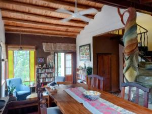 a dining room with a wooden table and chairs at Casa Amarilla in Mina Clavero