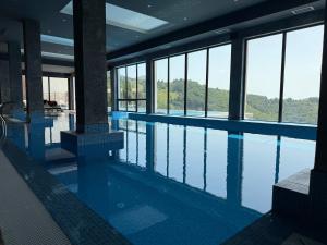 a swimming pool with a view of the mountains at Gold Elegant & Spa Kop in Kopaonik