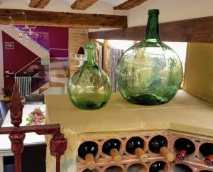 two green glass bottles sitting on top of a table at Casa Rural Los Carros in San Asensio +18 photos