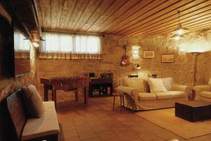a living room with couches and a table and a piano at Casa da Alvarinha. Privacidade, Conforto, Natureza in Paredes