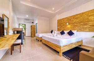 a hotel room with two beds and a desk at The Bulin Residence in Lamai