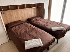 NervianoにあるRiVaLoVEの部屋に並んで置かれた2つのベッド +10枚の写真