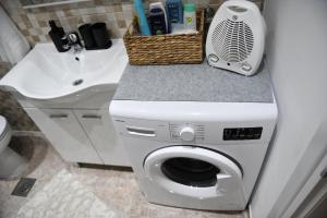 a washing machine in a bathroom with a sink at Apartman LUCIA 2 in Ðakovo