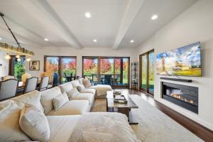 a living room with a large couch and a fireplace at Maynard Rocks IV at Elk Creek in Banner Elk